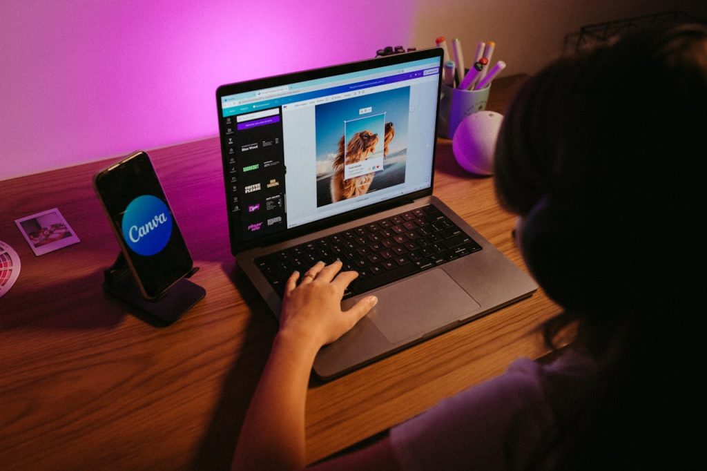 Teen working on graphic design using laptop at home with creative tools.